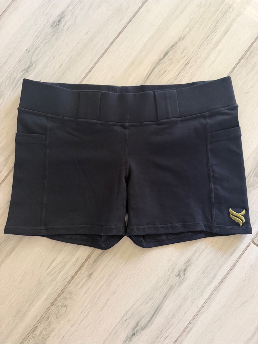 Black Athletic Stretch Shorts with Subtle Gold Emblem